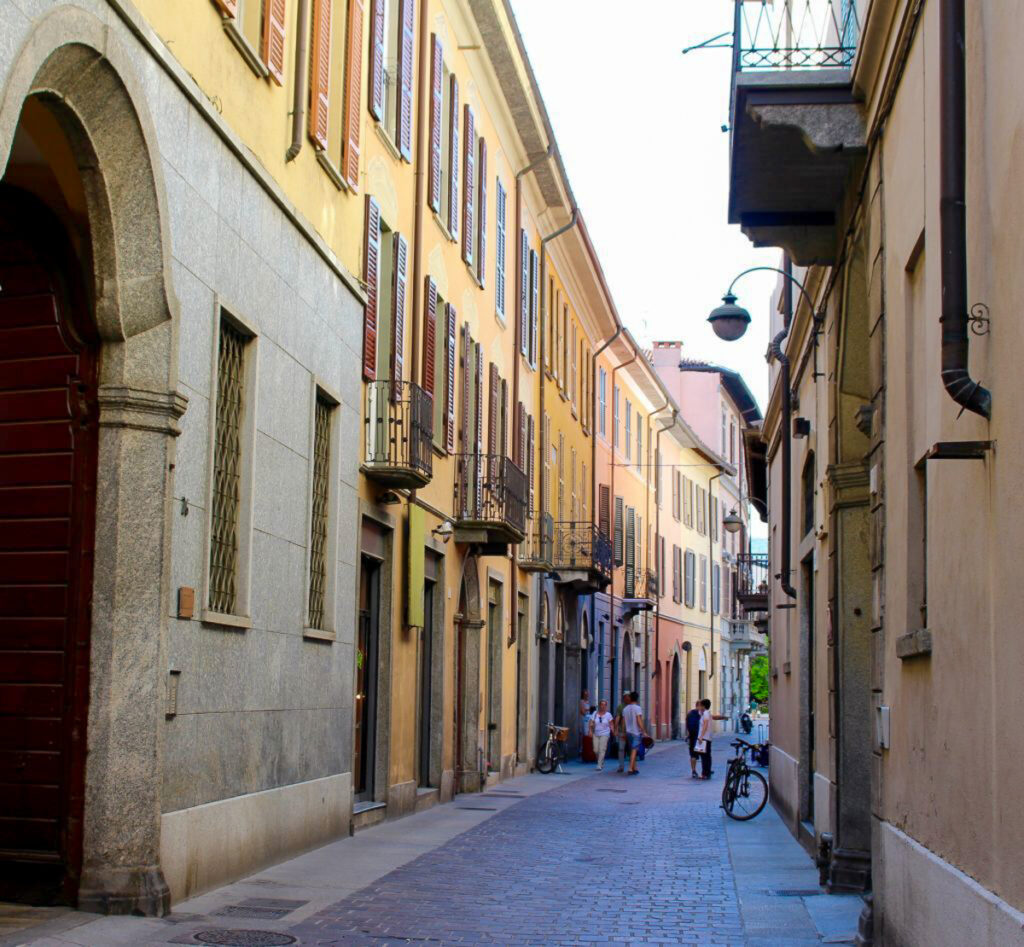 A cute street in the city of Como. This is one of the must-see towns on a day trip to Lake Como from Milan.