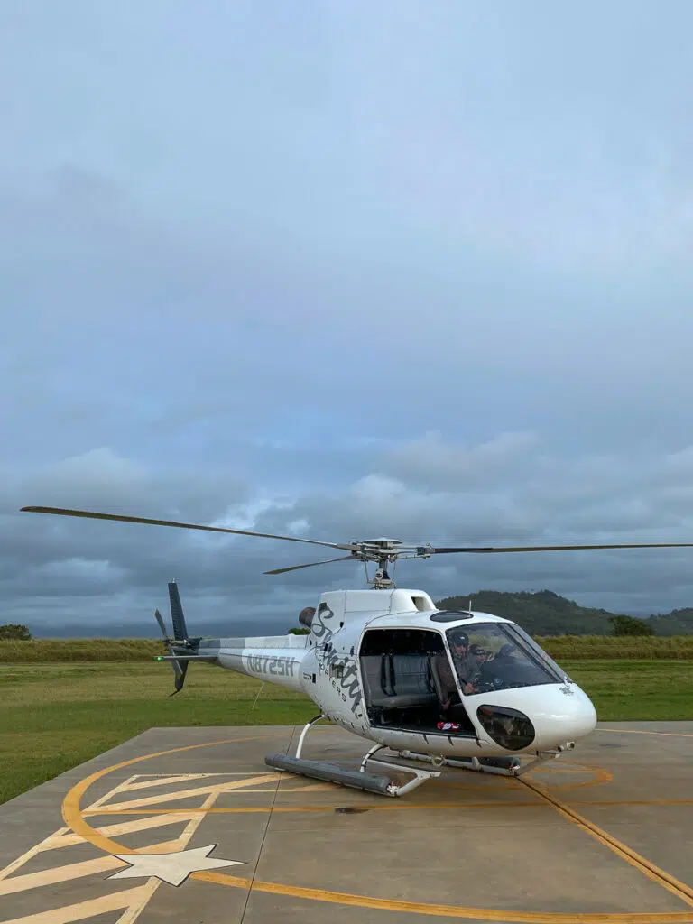 A helicopter with its doors open. This tour is a not-to-miss adventure when you visit Kauai.