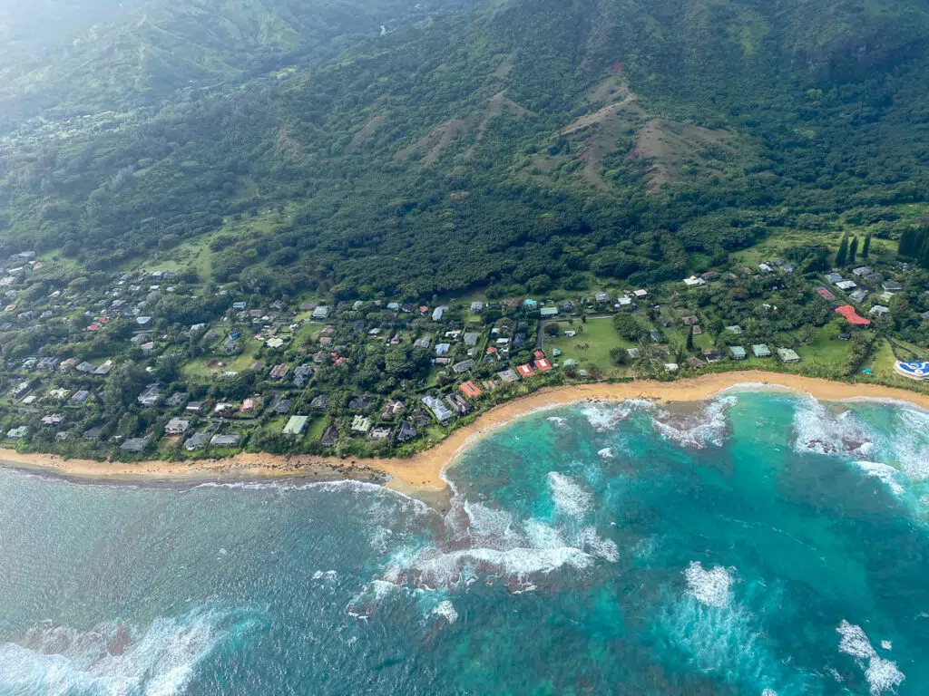 Relaxing view of Kauai's North Shore. Lush mountains with houses near the beach.