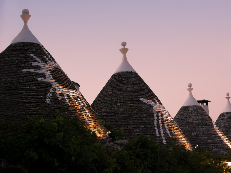 Trulli huts at sunset. Staying in a hut is one of the best things to do in Alberobello