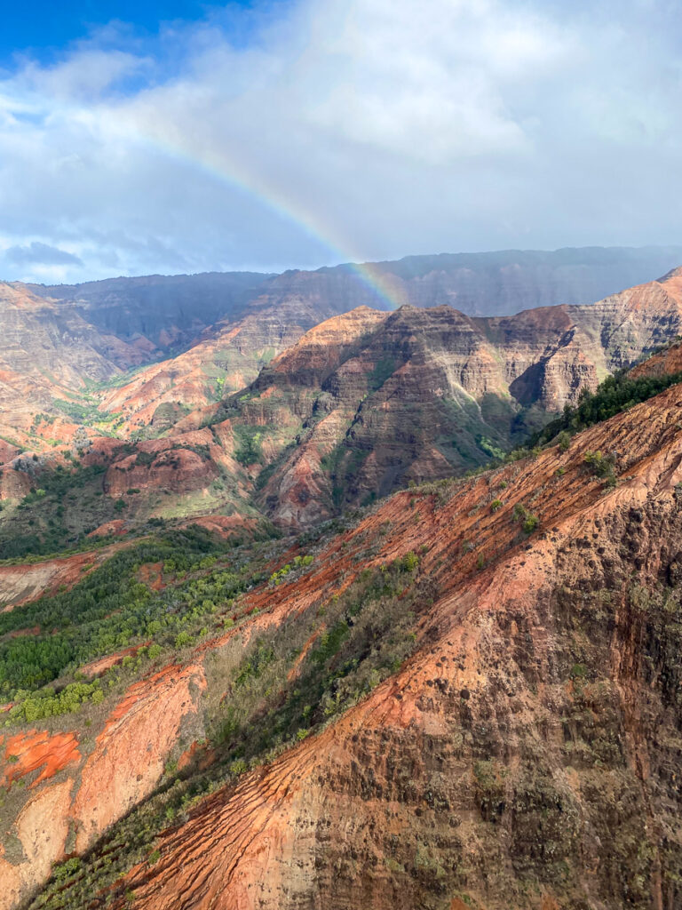 A beautiful rainbow passing over the Waimea Canyon in Kauai.
