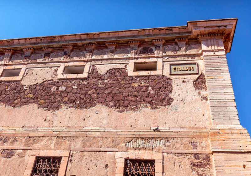 Outside of the grain storehouse in Guanajuato with small windows and exposed brick
