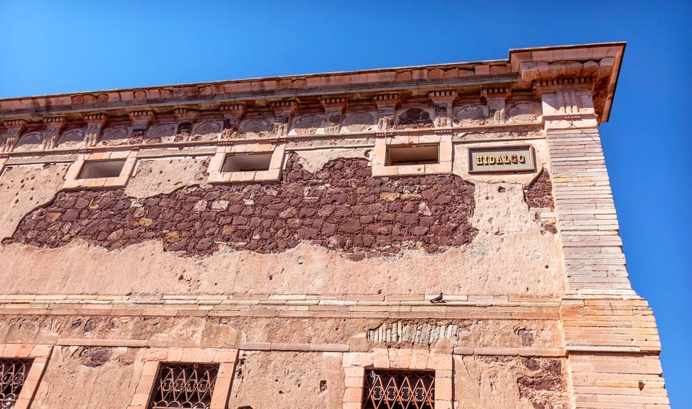 Outside of the grain storehouse in Guanajuato with small windows and exposed brick