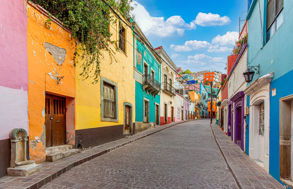 A beautiful street in Mexico featuring colorful colonial architecture