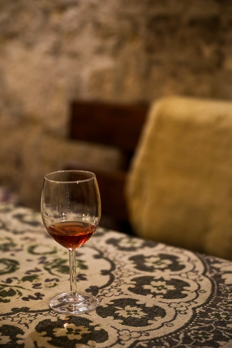 A glass of wine on a table at a cellar in Budapest