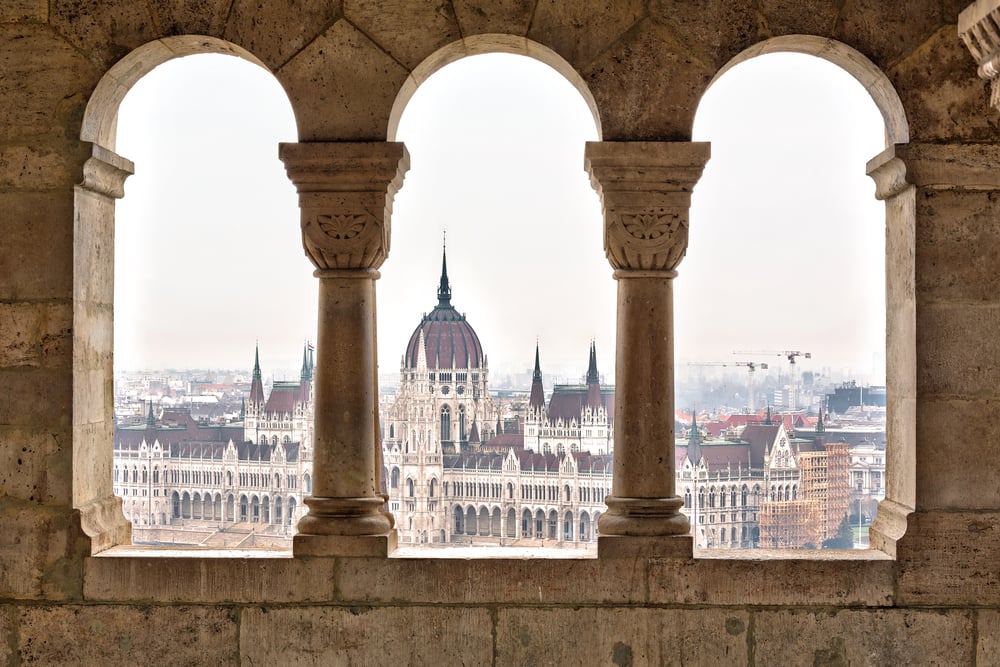 Arched windows of Fisherman's Bastion overlooking the House of Parliament in Budapest