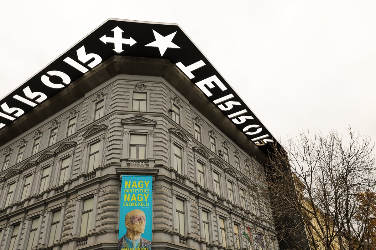 Colorful poster hanging outside the House of Terror in Budapest