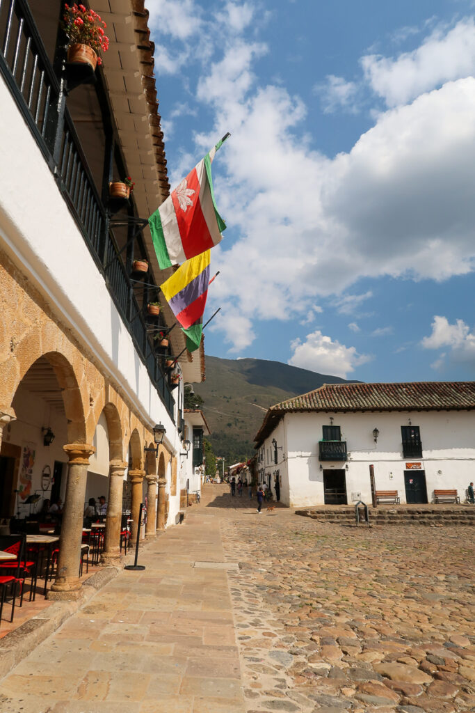 Flags on a building in Plaza Mayor. Taking a day trip to Villa de Leyva is one of the things to do in Bogota.