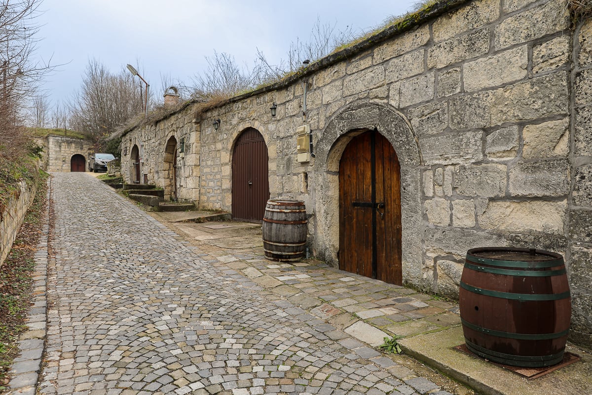 Old barrels outside a winery along a quiet cobblestone street in Budapest