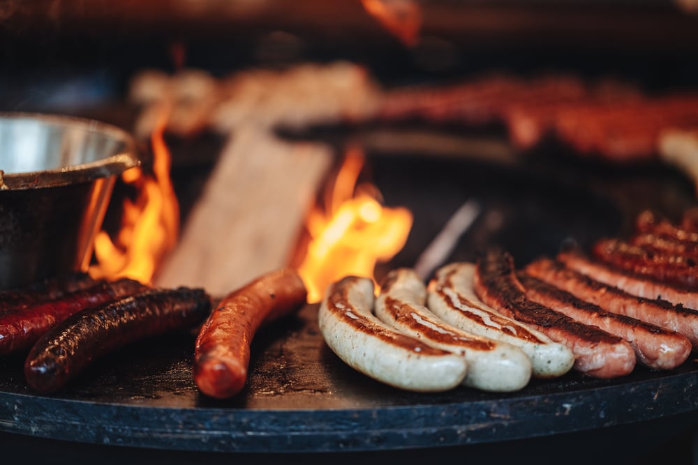 Sausages being grilled by an open fire at the Luxembourg Christmas market