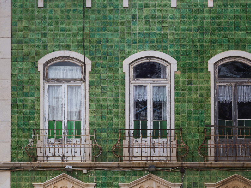 A beautiful green tiled facade of a building in Portugal