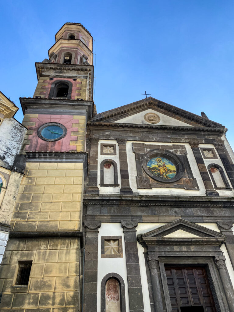 Old front exterior design of Chiesa di San Giovanni Battista in Vietri sul Mare under the blue sky