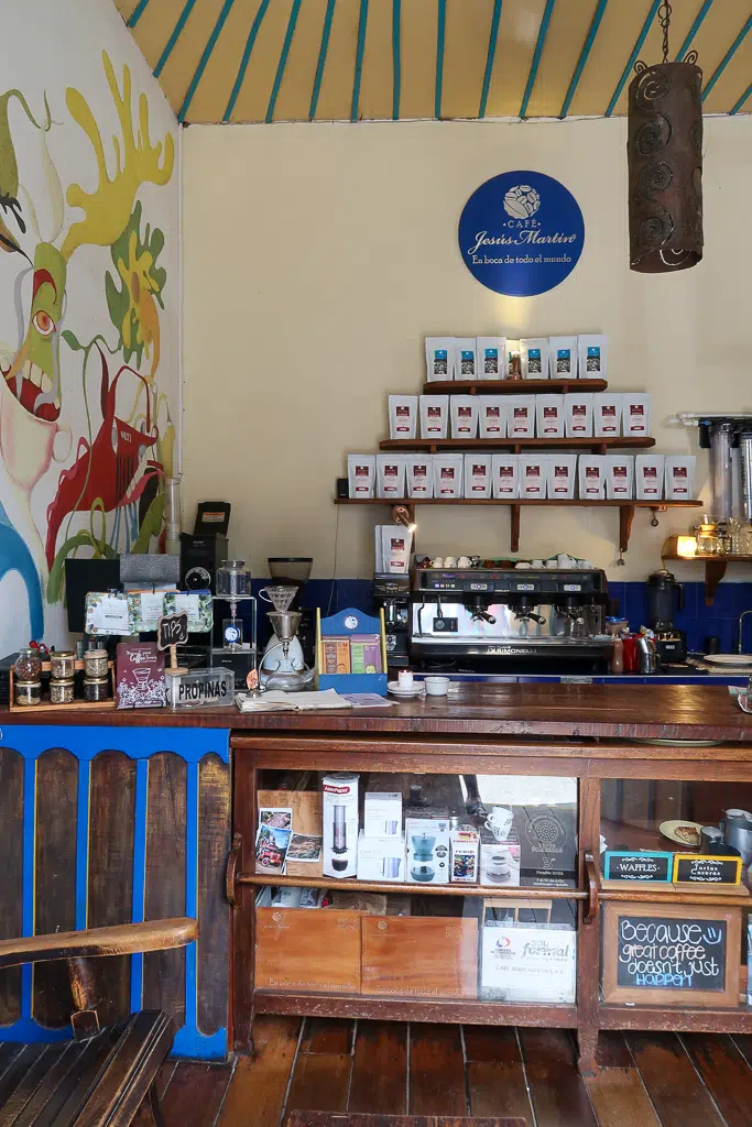 Inside a coffee shop in Salento displaying coffee machines and different coffee types. Visiting coffee shops is one of the things to do in Salento, Colombia to learn more about its rich history.