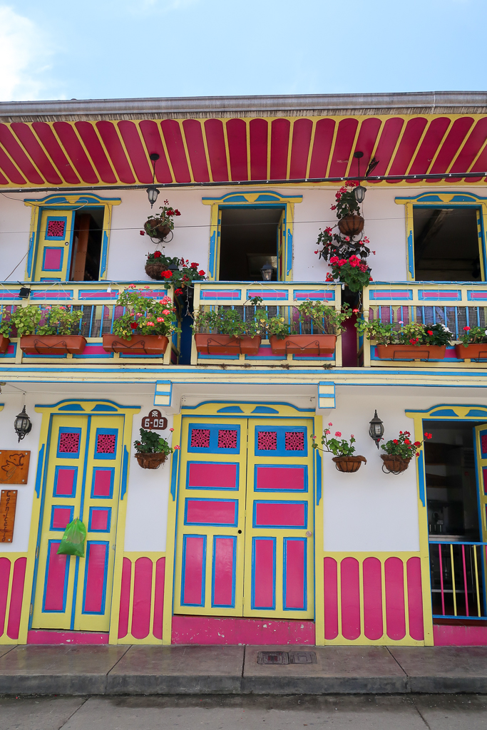 Colorful decorated houses in Salento, Colombia painted in pink, blue, and yellow