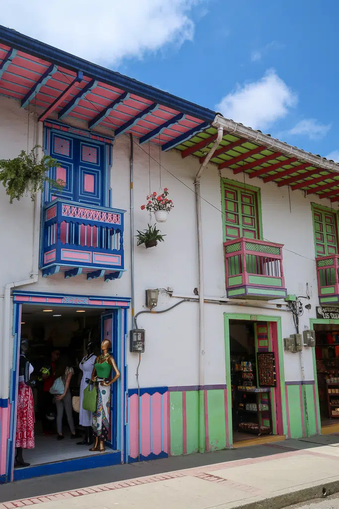 Colorful boutique shops in Salento, Colombia painted in blue, pink, and green