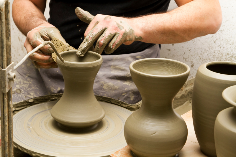Molding clay pottery in different shapes. One of the best things to do in Vietri sul Mare is attending a ceramic workshop.