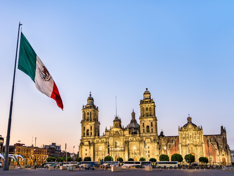 Cathedral and Mexican flag in Mexico City Zocalo - a must see in Mexico City