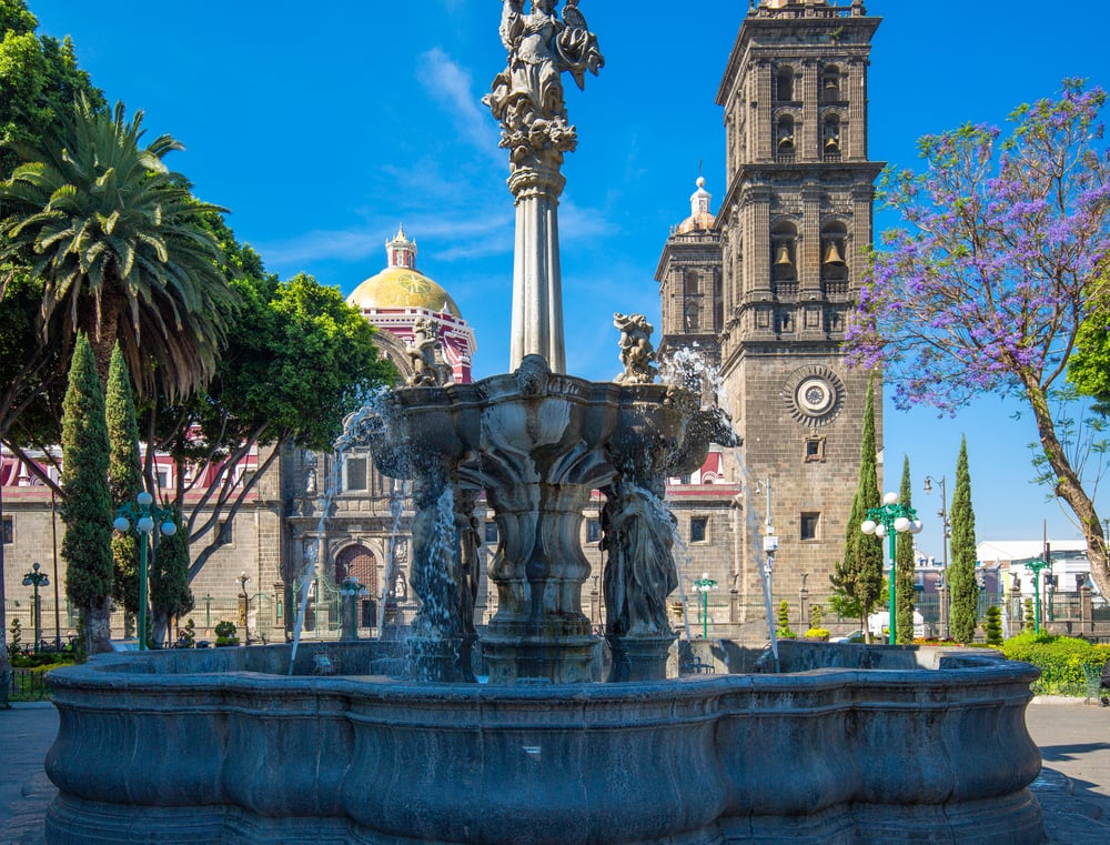 A fountain and church in the background in the Zocalo, Mexico