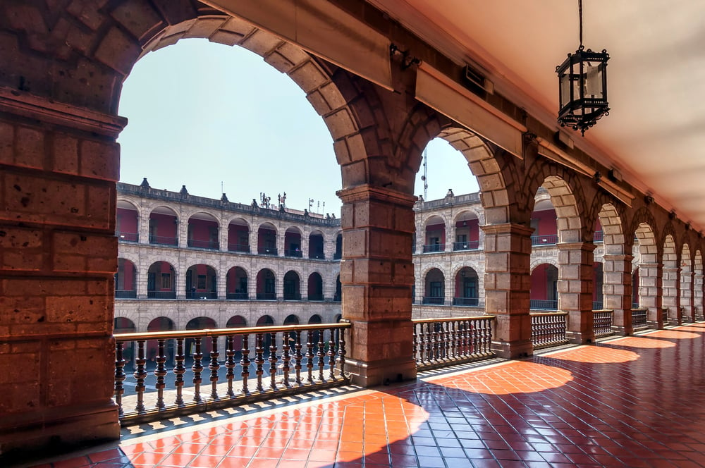 National Palace in Mexico city with brick arches and a large courtyard