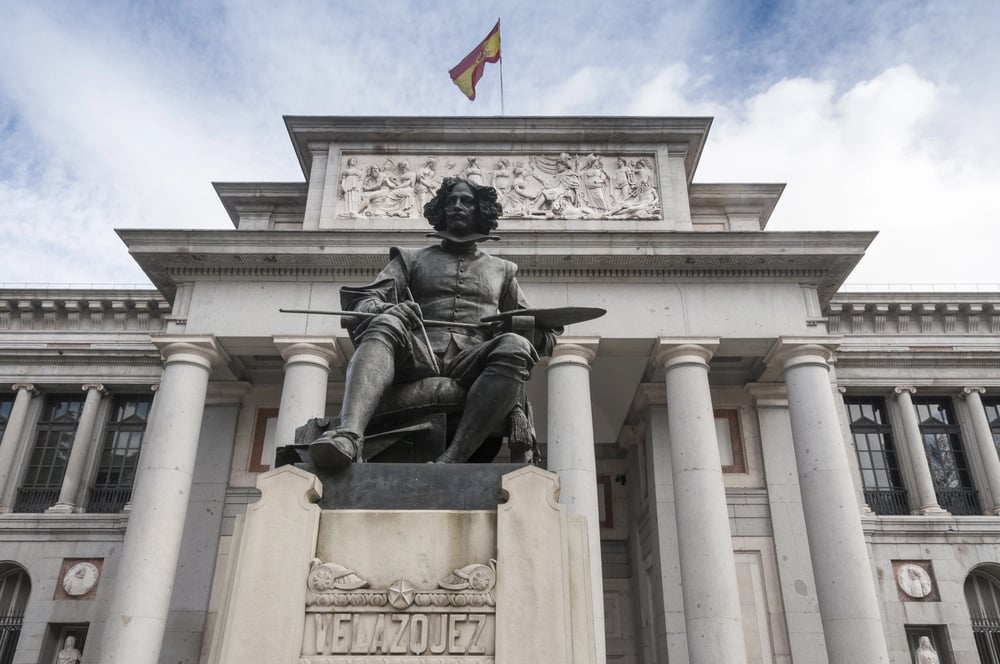 The view of Prado Museum outside with a statue in front of it. Be sure to visit this art venue during your 24 hours in Madrid.