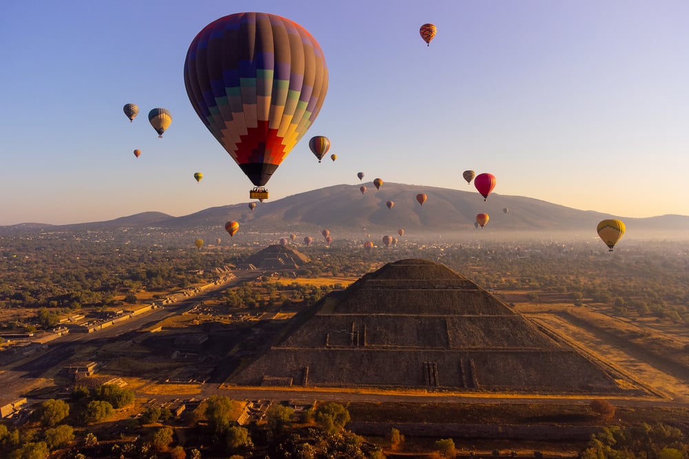 Hot air balloons flying over the pyramids in Teotihuacan