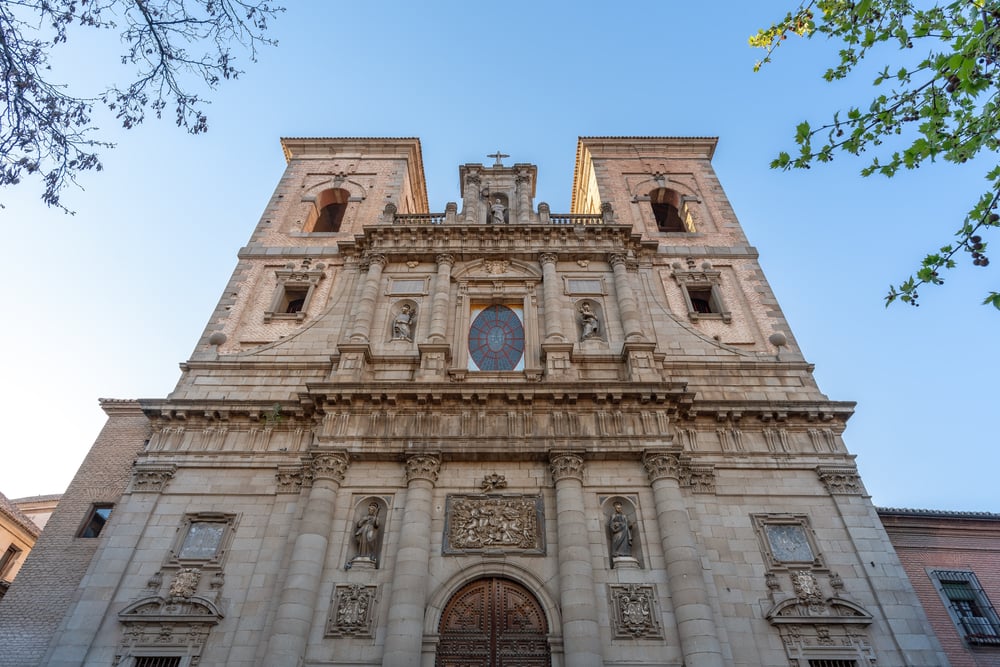 San Ildefonso Church from a low angle with a sunny, blue sky behind