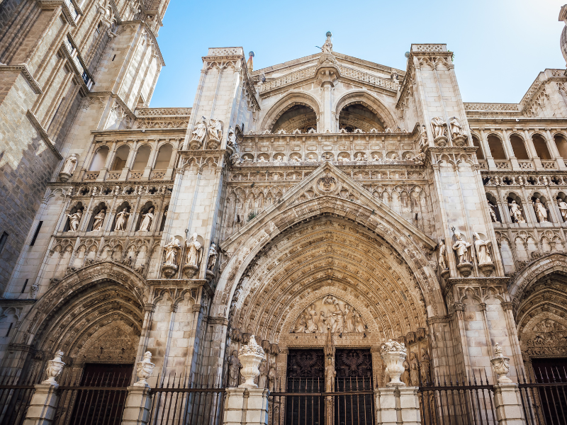 Intricate exterior design of the Primatial Cathedral of Saint Mary of Toledo on a sunny day