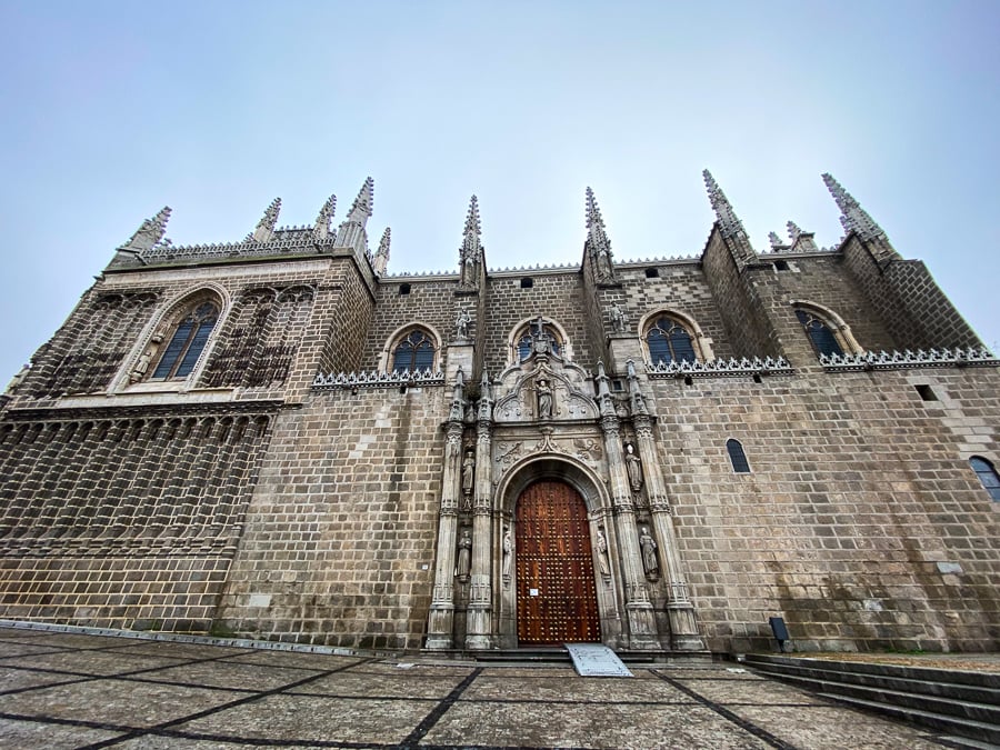 View of the historical Monastery of San Juan de los Reyes in Toledo, Spain under clear sky