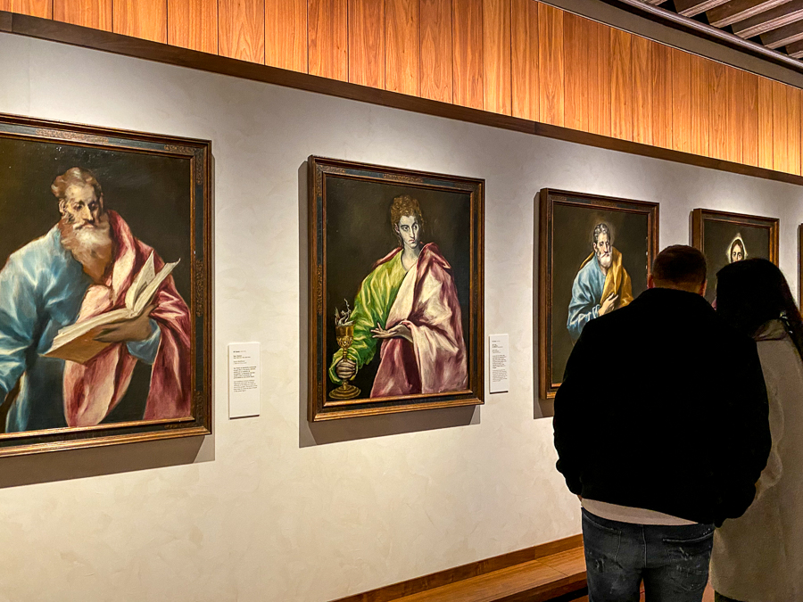 A couple checking out paintings displayed inside the Greco Museum. Explore more of Toledo's fine arts in this museum during your day trip to Toledo from Madrid.