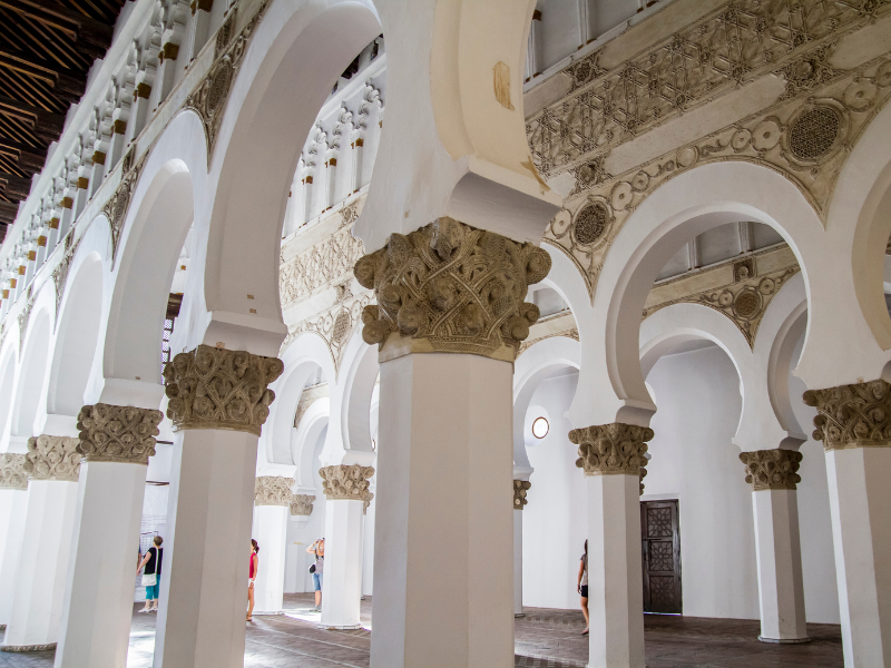 White and gold trims of Mudejar arches in the Synagogue of Santa Maria la Blanca. This historical site is a must-see on your day trip to Toledo from Madrid.