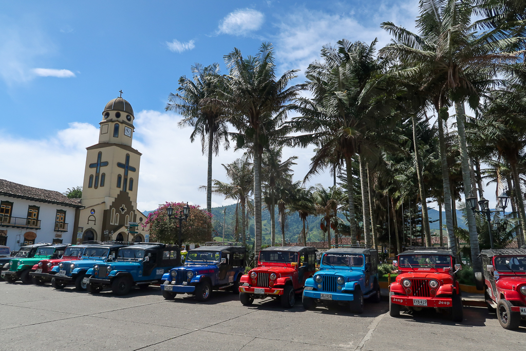 Colorful Willys parked in the Salento Main Square near the church. Riding a Willy is a fantastic experience in Salento, Colombia.
