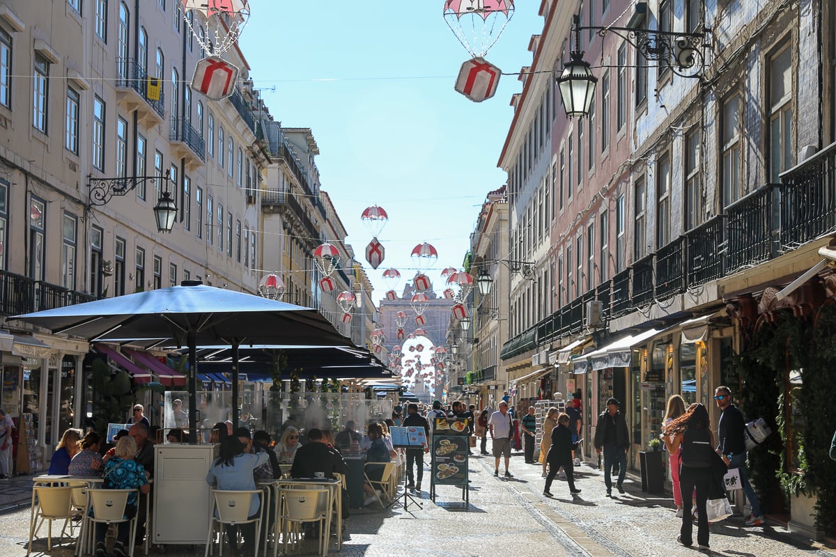 Busy street of Baixa filled with shops and cafés on a sunny day