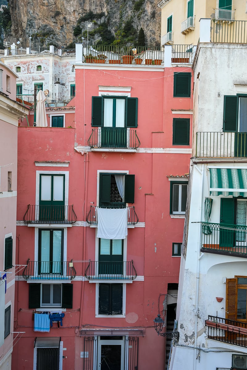 A cluster of old and colorful buildings in Atrani. Spending an evening in Atrani is a great activity to include in your Amalfi Coast itinerary.