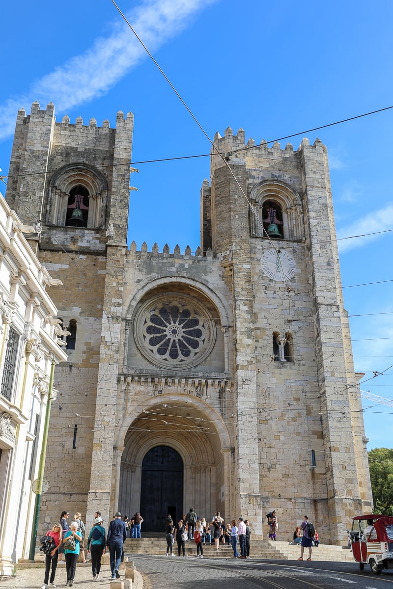 Lisbon Cathedral with people waiting out the front door