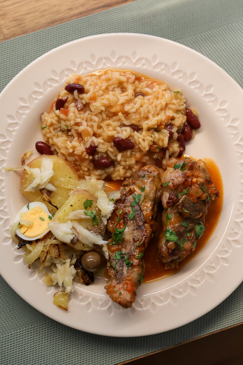 Arroz de feijão, migas com entrecosto, and bacalhau à brás in one plate