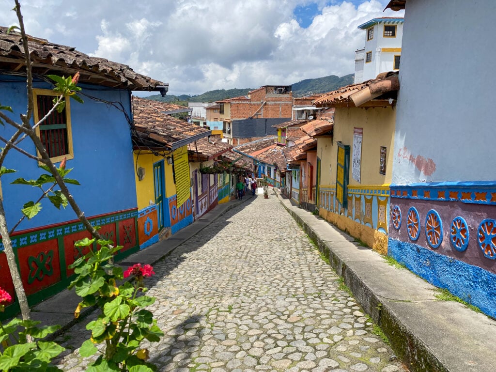 Colorful downhill cobblestone street in Guatape, Colombia