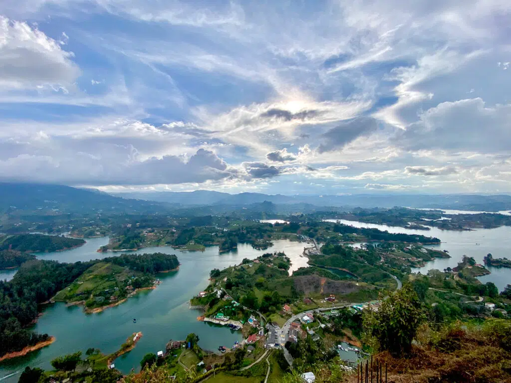 Aerial view of the Guatape Lake surrounded by lush forest trees