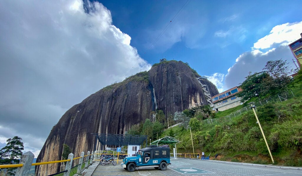 View of La Piedra del Peñol from the road. In this ultimate guide of things to do in Guatape, climbing El Peñol is one of the most recommended.