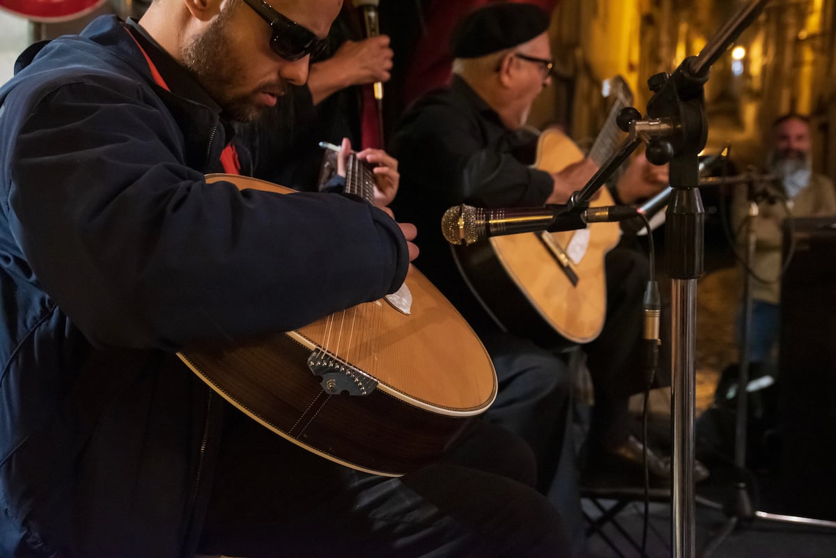 Two guitarists at a Fado performance in Chiado