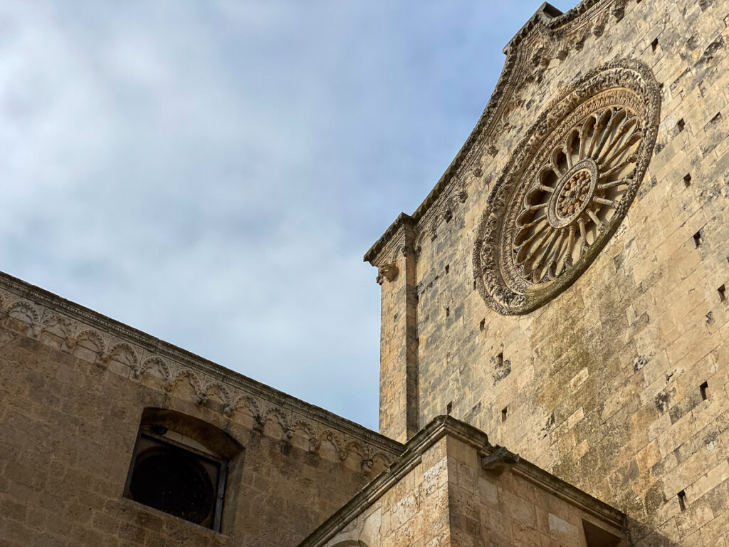 Ornate rose window of a church in Ostuni, Italy - one of the best places to visit in Puglia
