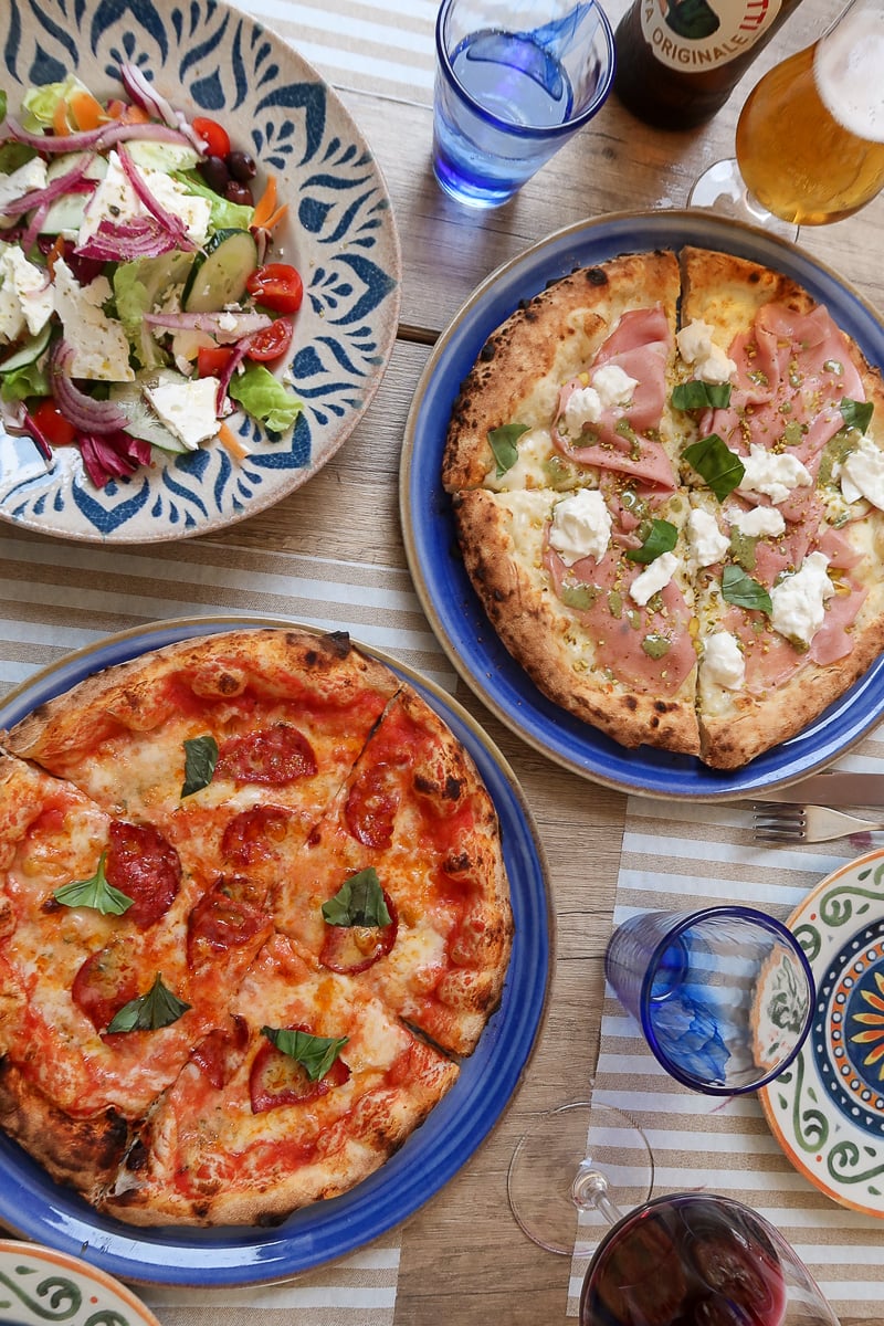 Delicious pizza, salad, wine, and beer in Italy