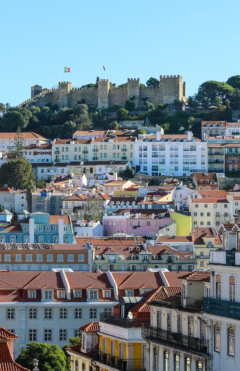 Colorful buildings of Lisbon and a castle in the background