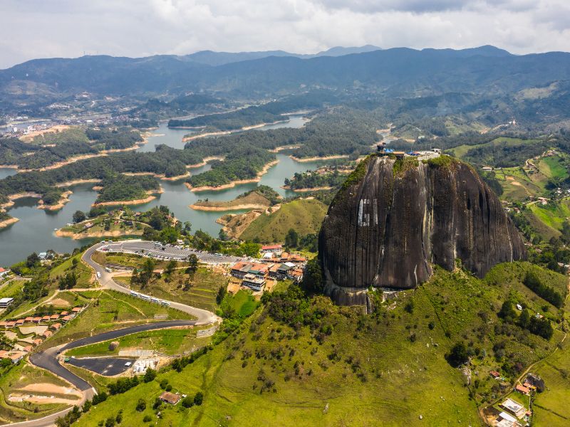 Aerial view of Peñol Rock and the city of Guatape. Get a bird's eye view of this beautiful sight when you book a paragliding tour - one of the best things to do in Guatape.