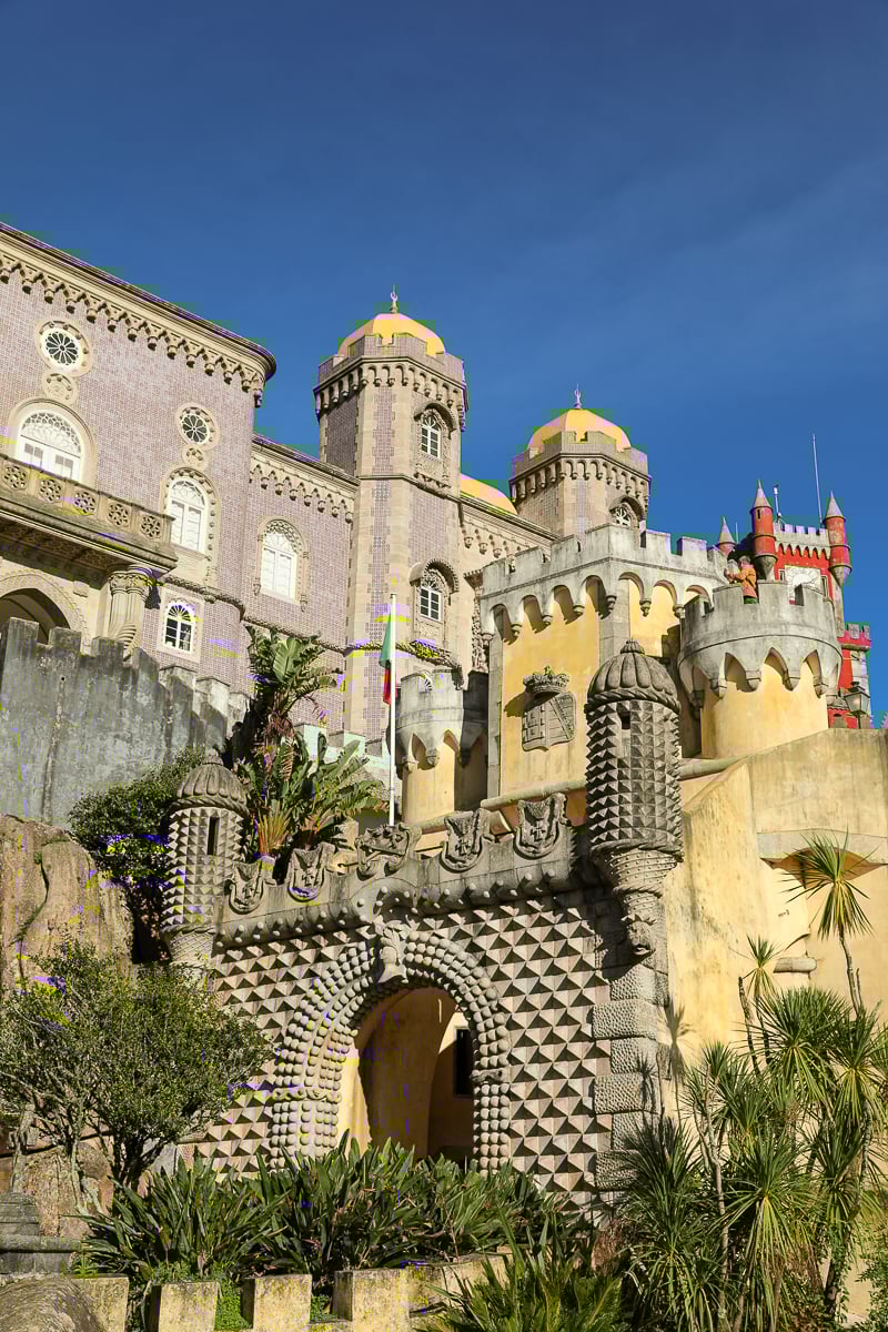 Stunning architecture of Pena Palace as viewed from the ground on a sunny day