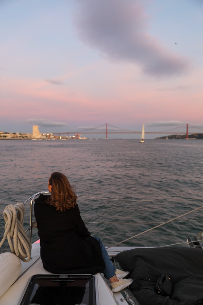 Maddy on a boat sailing along the Tagus River at sunset