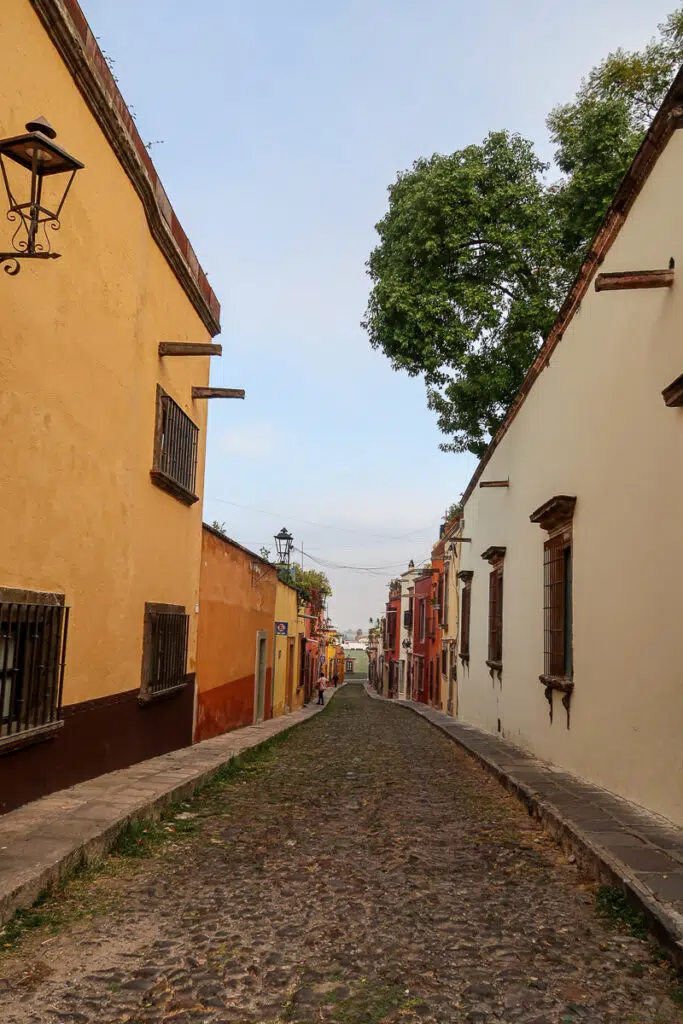 Narrow street in San Miguel de Allende. Take a chance to explore the city by going on a historical walking tour - one of the magical things to do in San Miguel de Allende, Mexico.