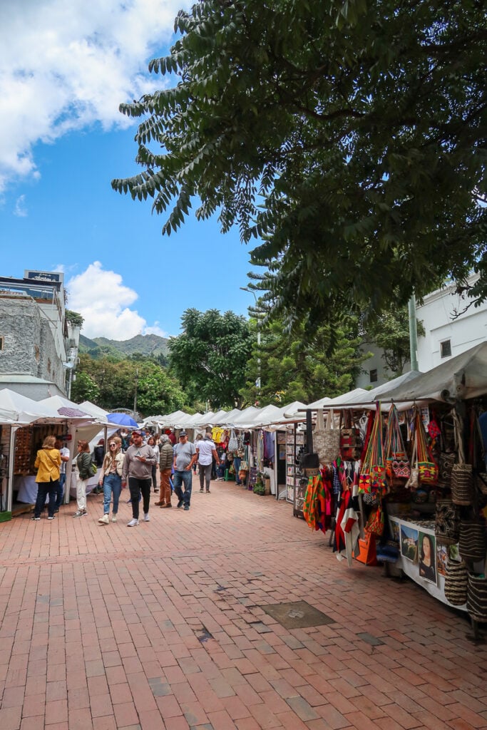 Flea market in Bogota with stalls lined on both sides of the street