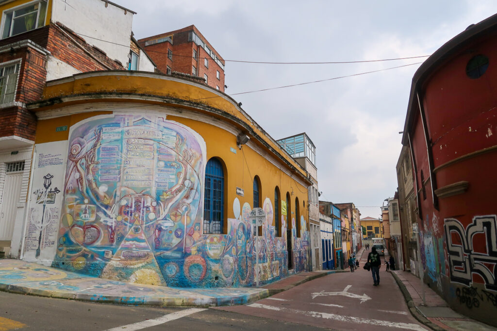 Colorful mural in a street corner. The graffiti tour is one of the top tours in Bogota.