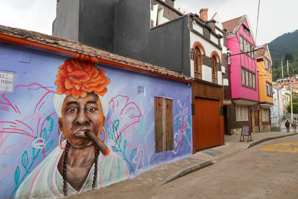 Beautiful street art of a woman with tobacco in her mouth. Going on a graffiti tour is one of the fun things to do in Bogota, Colombia.