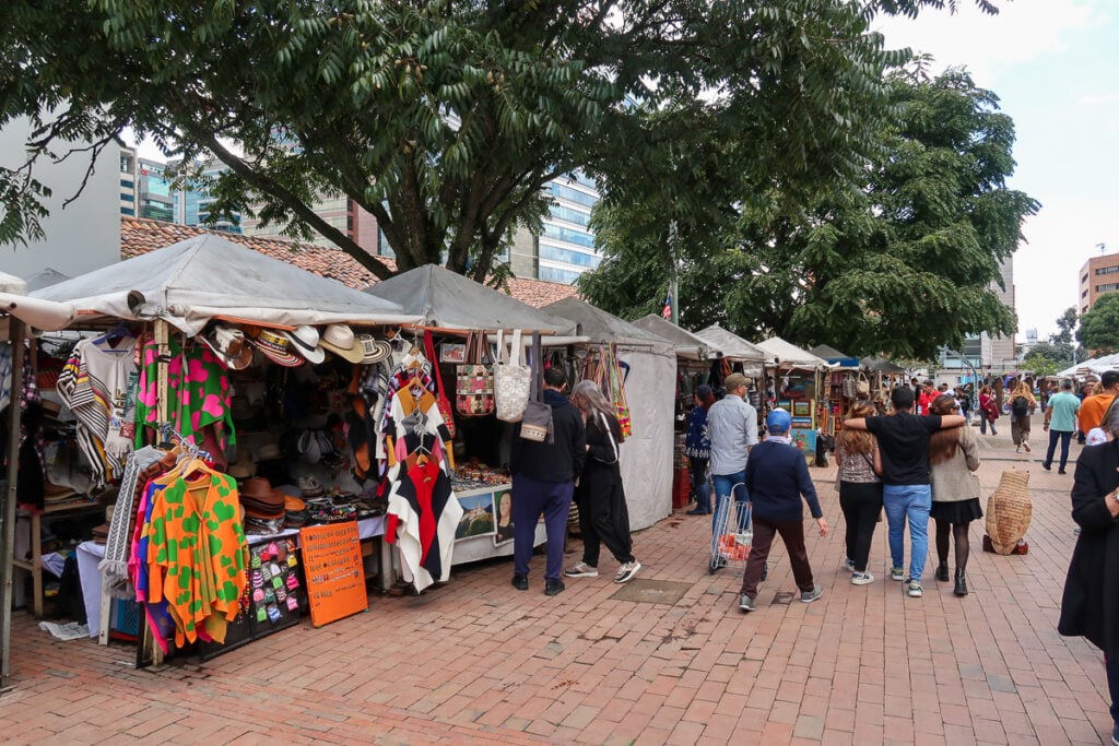 People wandering around the stalls at the Sunday Flea Market in Usaquen. Going to this outdoor market is one of the things to do in Bogota.